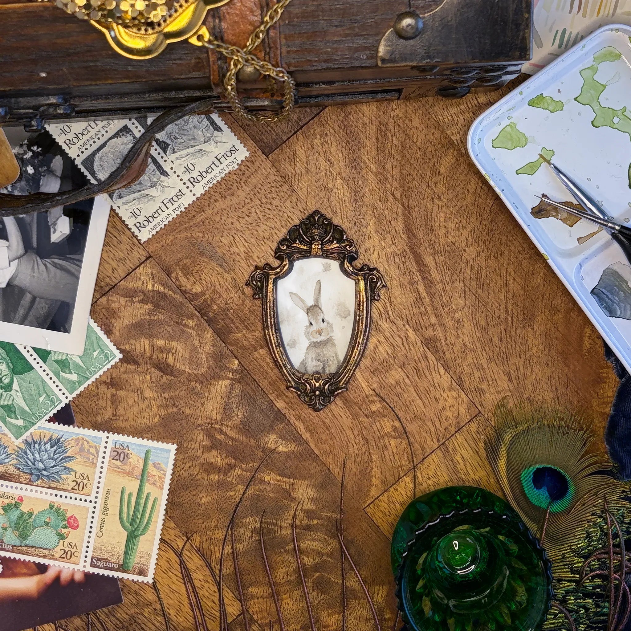 Art and Fairy Magic theme craft materials on a wooden table, with stamps, a frame, and a paint tray