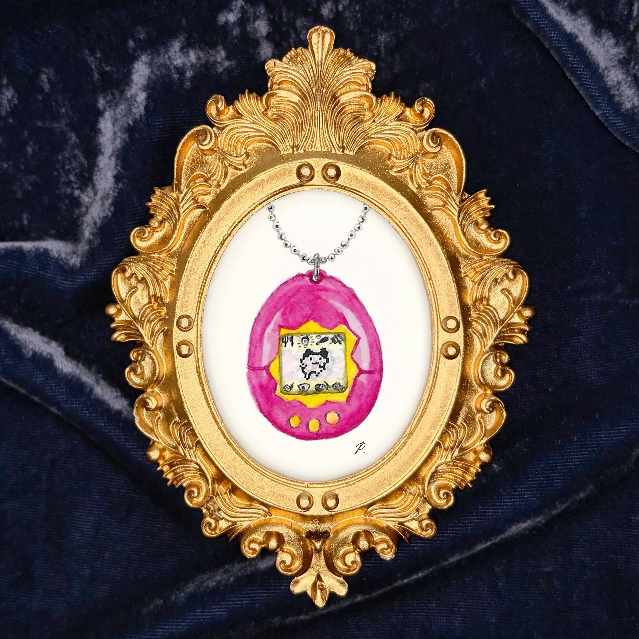 Art Fairy Magic pendant framed in ornate gold on a dark fabric background, with a pink oval charm