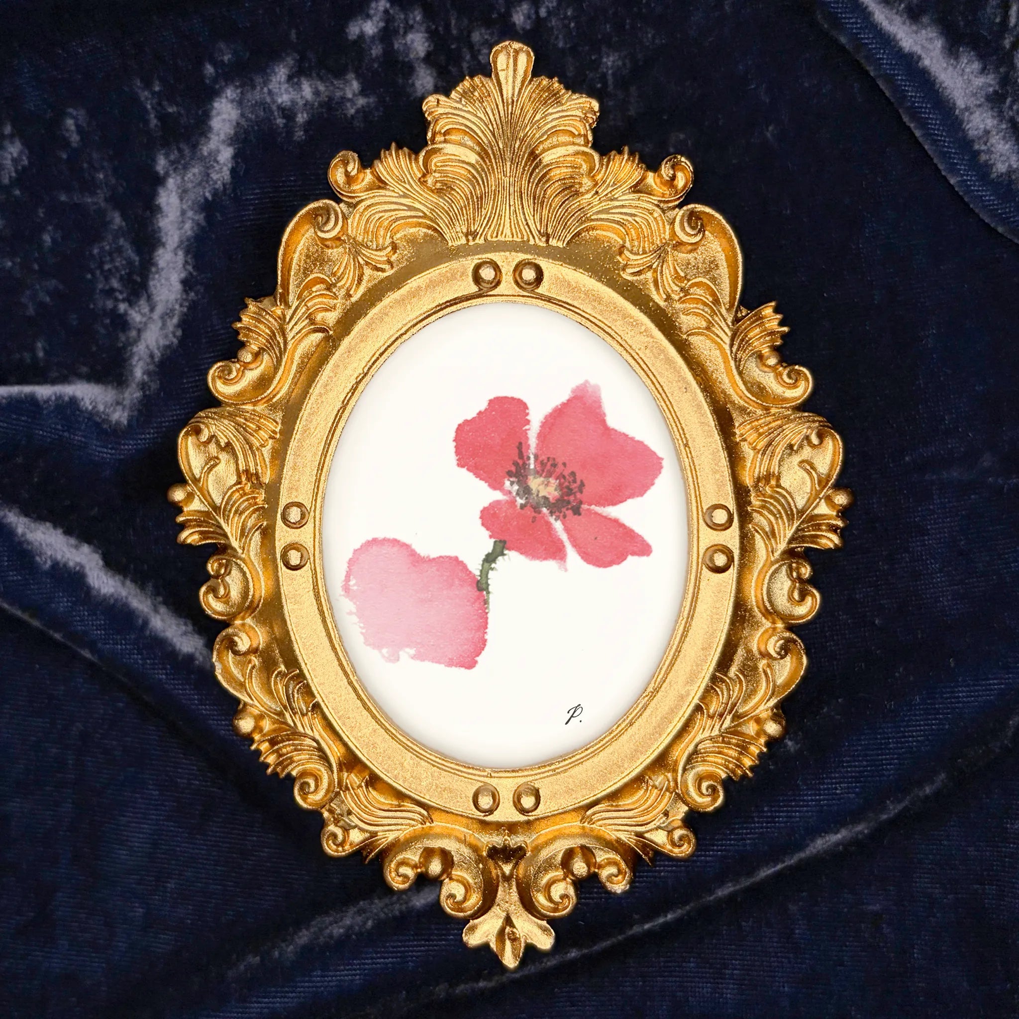 Art fairy magic in a gilded oval frame with pink flower paint on a dark blue fabric background