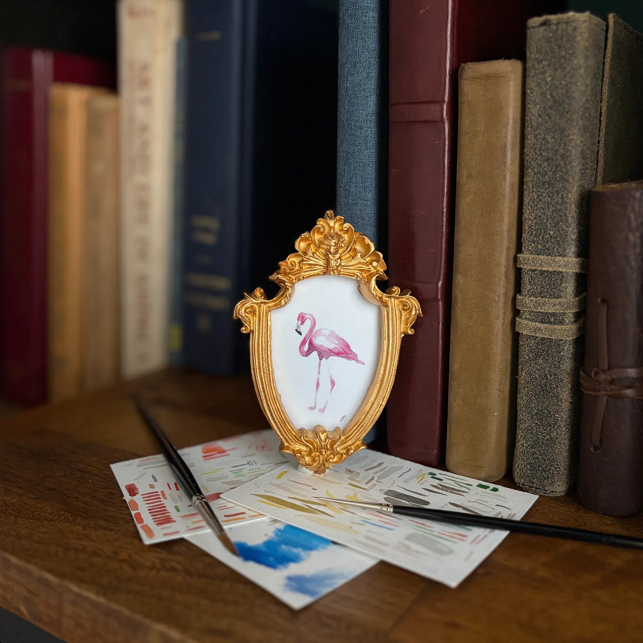 Art and Magic theme with a Fairy figure in a gold frame beside books and colorful papers on a desk