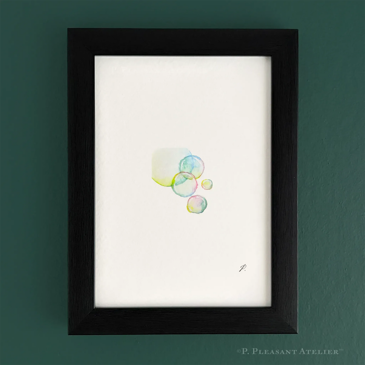 Framed minimalist art print featuring a cluster of translucent watercolor bubbles on a white background, housed in a black wood frame and mounted on a dark green wall. Signed by the artist with "P."
.