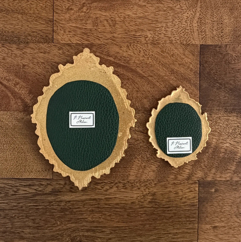 Art fairy magic themed wall plaques with green ovals and gold trim on a wood panel background