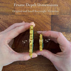 Two hands hold two narrow gold-toned decorative frames against a wooden floor background, with text reading 'Frame Depth Dimensions' and 'Original and Small Rectangle - Victorian' plus '1/4"' measurements.