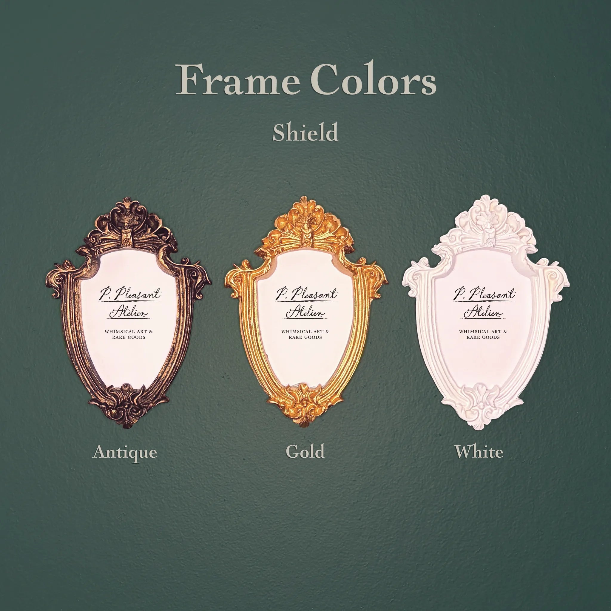 Three decorative shield-shaped picture frames shown on a dark green background with the text 'Frame Colors Shield' and labels 'Antique', 'Gold', and 'White'.