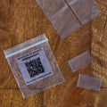 Art fairy magic themed craft cards on clear plastic sleeves on a wooden table with scan instructions visible