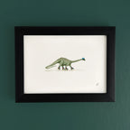 Art fairy magic illustration in a black frame, showing a green figure holding a blue bird above roller skates
