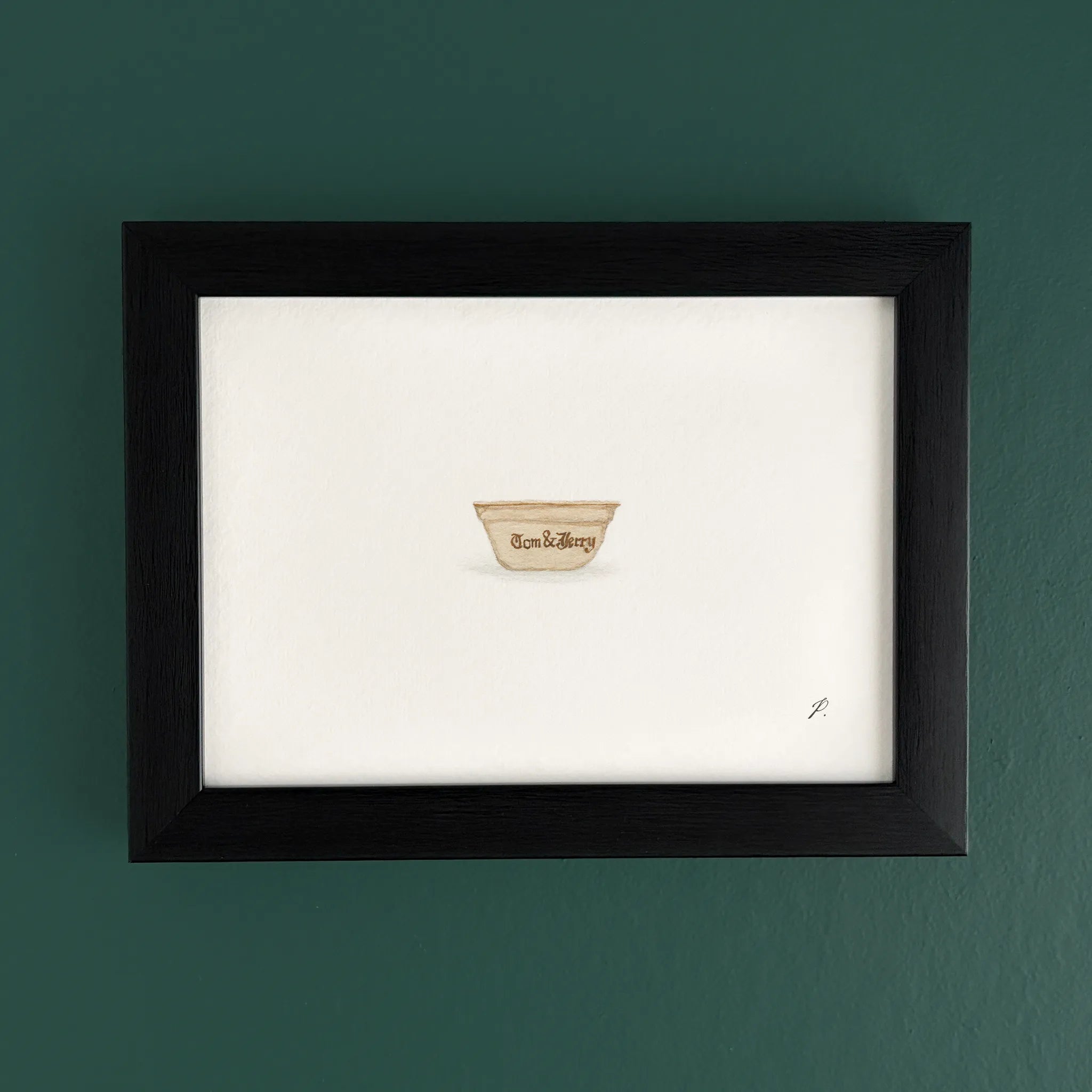 Art print in a dark wooden frame on a teal wall, with a small cup shaped emblem near the bottom