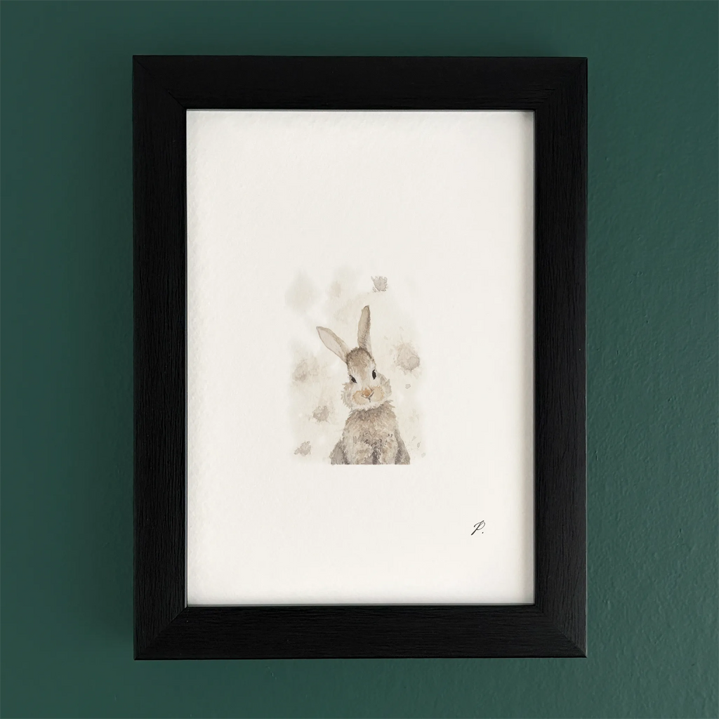 Art fairy magic illustration of a rabbit with small floating shapes inside a dark wooden frame