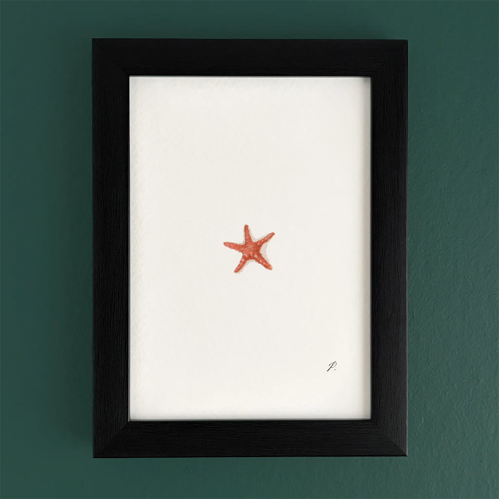 Art frame on a teal wall with a small red starfish drawing, leaving most of the canvas blank