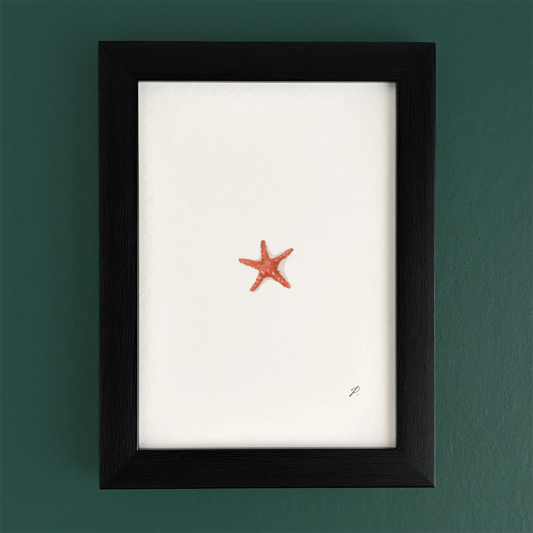 Art frame on a teal wall with a small red starfish drawing, leaving most of the canvas blank