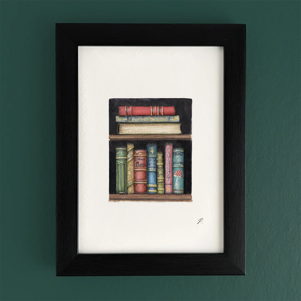 Art print in a black frame showing Magic and Fairy themed stacked books on a shelf