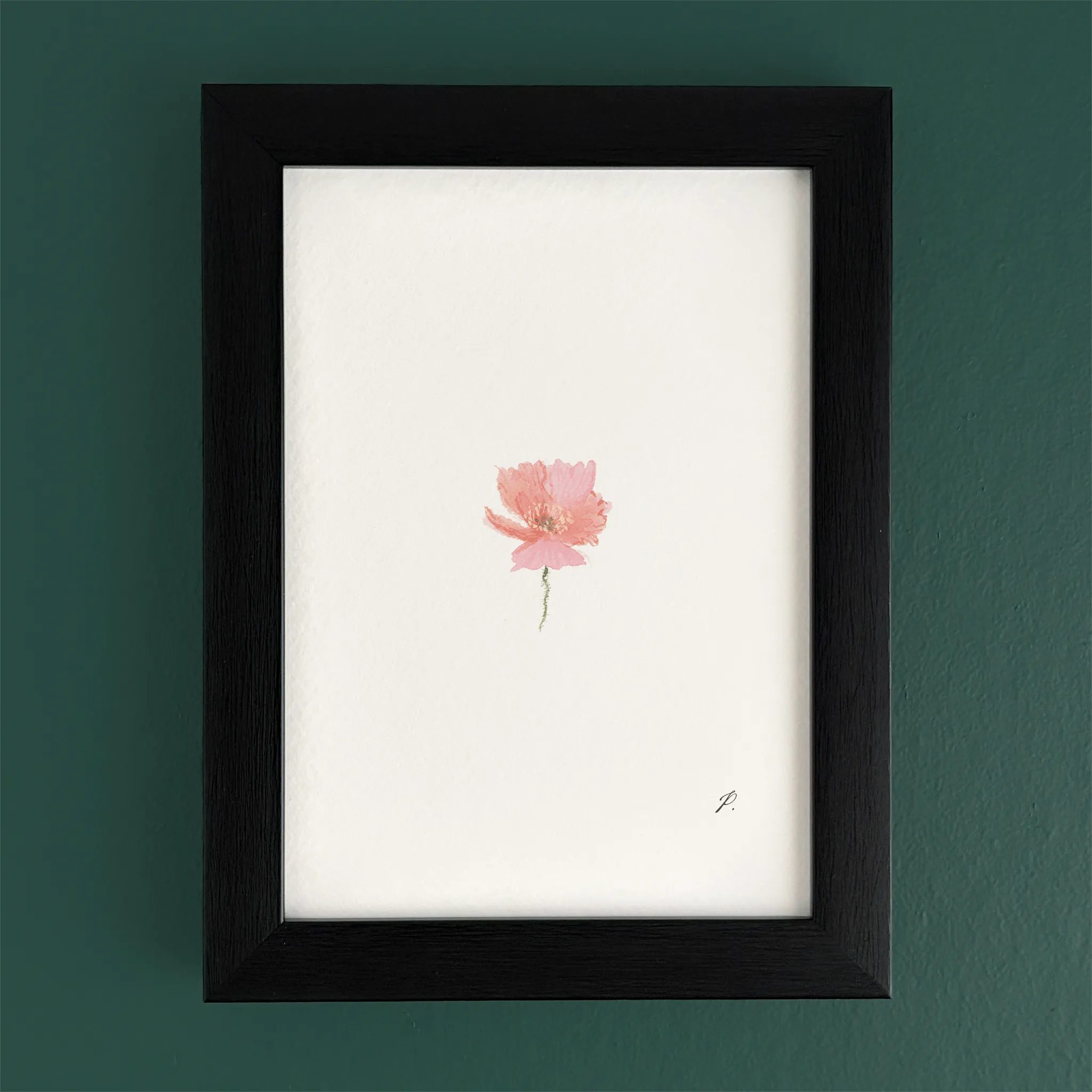 Art print in a black frame on a teal wall, with a small pink fairy flower and soft magic-style details