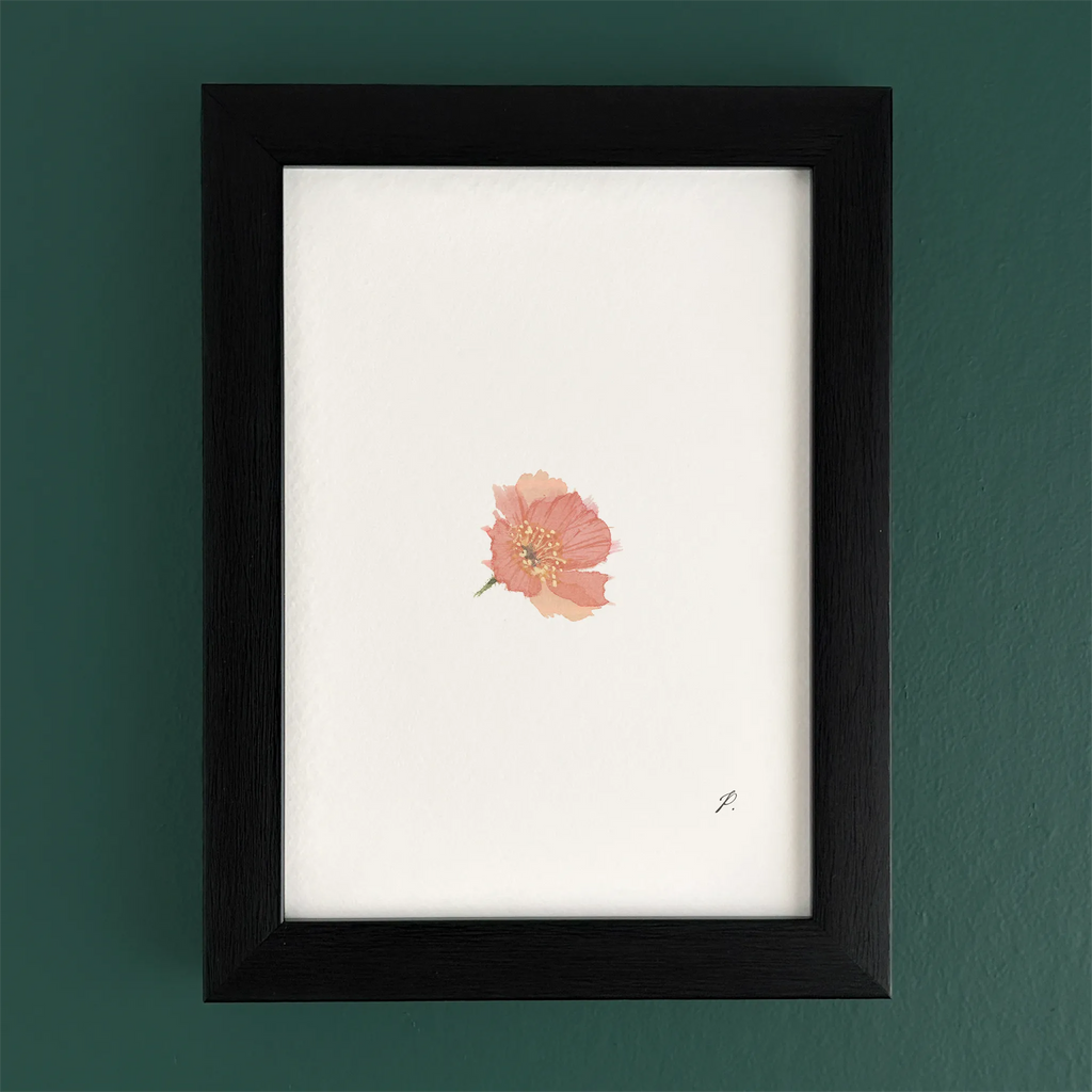 Art fairy magic theme print in a black frame on a green wall, with a small pink flower illustration