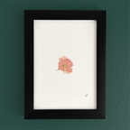 Art fairy magic theme print in a black frame on a green wall, with a small pink flower illustration