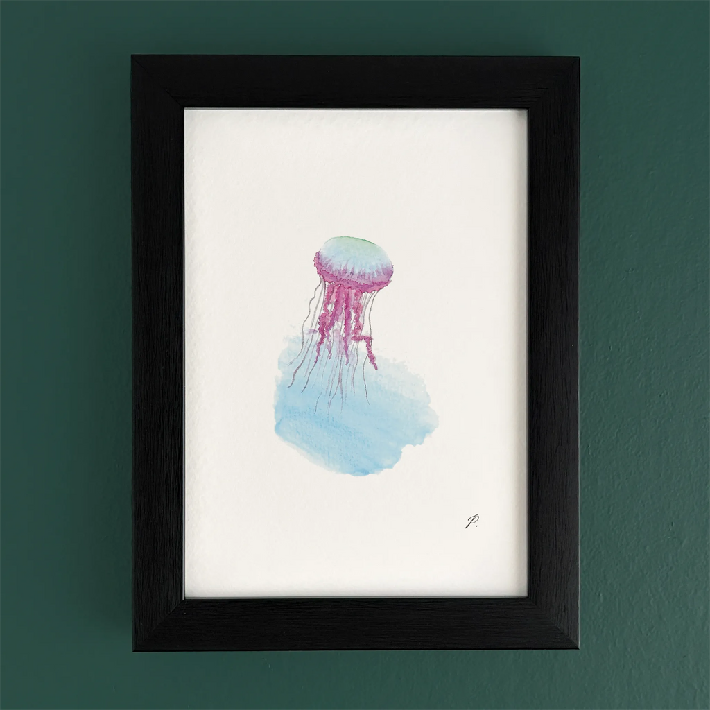 Art print in a black frame with a fairy jellyfish and flowing magic watercolor hues