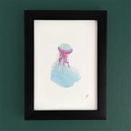 Art print in a black frame with a fairy jellyfish and flowing magic watercolor hues