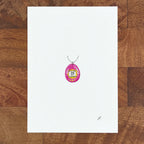 Art fairy magic pendant necklace with a silver chain and a pink oval charm on a white card