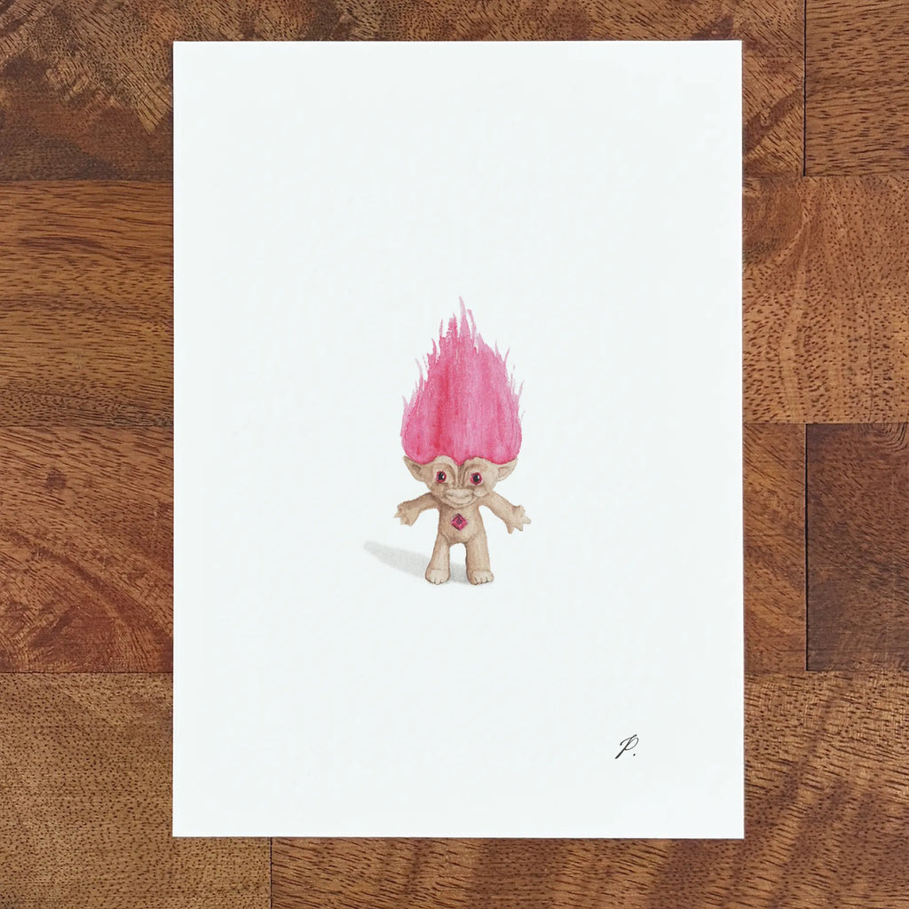Art fairy magic character with a pink flame-like hair tuft on a white sheet over a wooden table