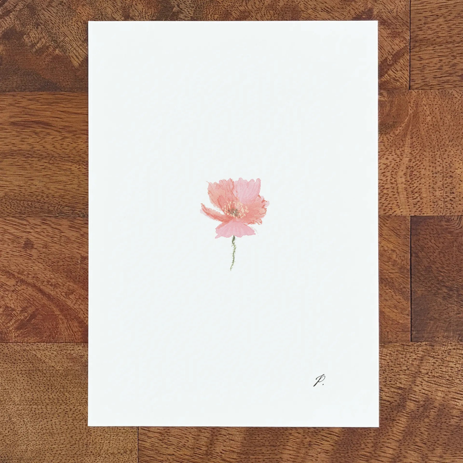 Art fairy magic theme card with a pink flower illustration on a white page atop a wooden table