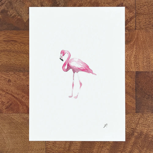 Art fairy magic illustration of a pink flamingo standing on a white sheet on a wooden table