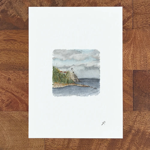 Art print on a white page showing a watercolor fairy tale style seascape with a small lighthouse and trees